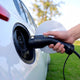 Type 1 connector of the Voldt® Portable Charger being plugged into a white electric car